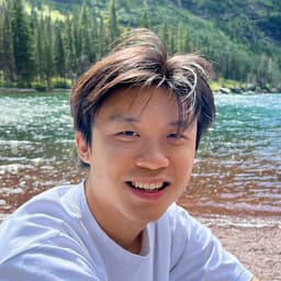 Picture of David smiling by a lake.